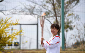 Azusa Iwashimizu participates in the Tokyo 2020 Olympic Torch Relay.