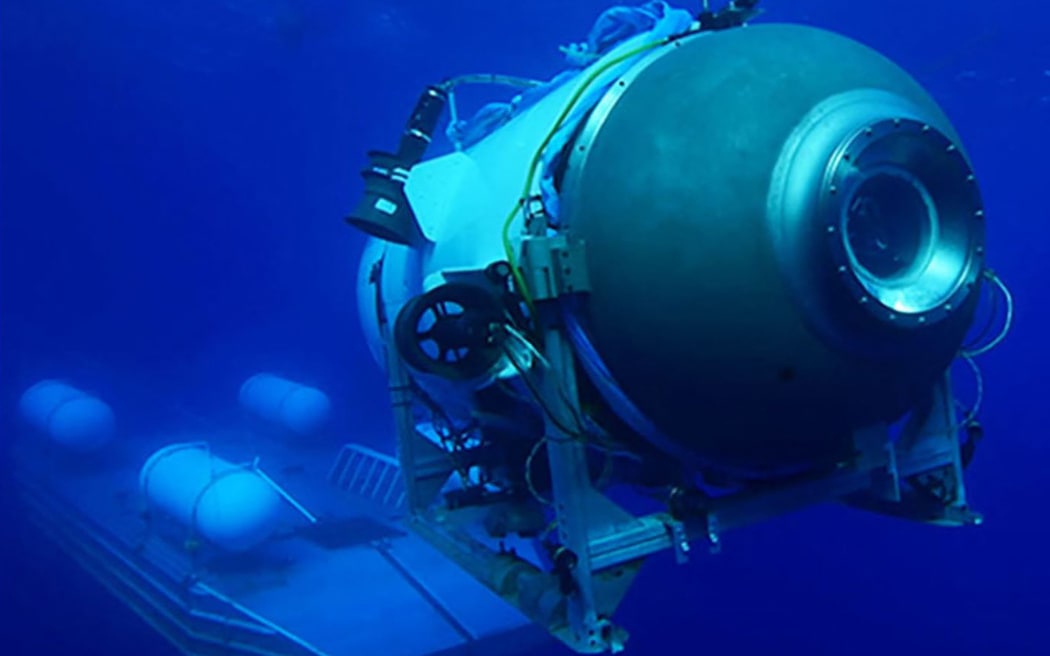 This undated image courtesy of OceanGate Expeditions, shows their Titan submersible launching from a platform. Rescue teams expanded their search underwater on June 20, 2023, as they raced against time to find a Titan deep-diving tourist submersible that went missing near the wreck of the Titanic with five people on board and limited oxygen. All communication was lost with the 21-foot (6.5-meter) Titan craft during a descent June 18 to the Titanic, which sits at a depth of crushing pressure more than two miles (nearly four kilometers) below the surface of the North Atlantic.