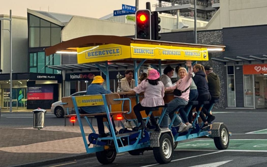 A 15-seater Beercycle bike on the road in Hamilton.