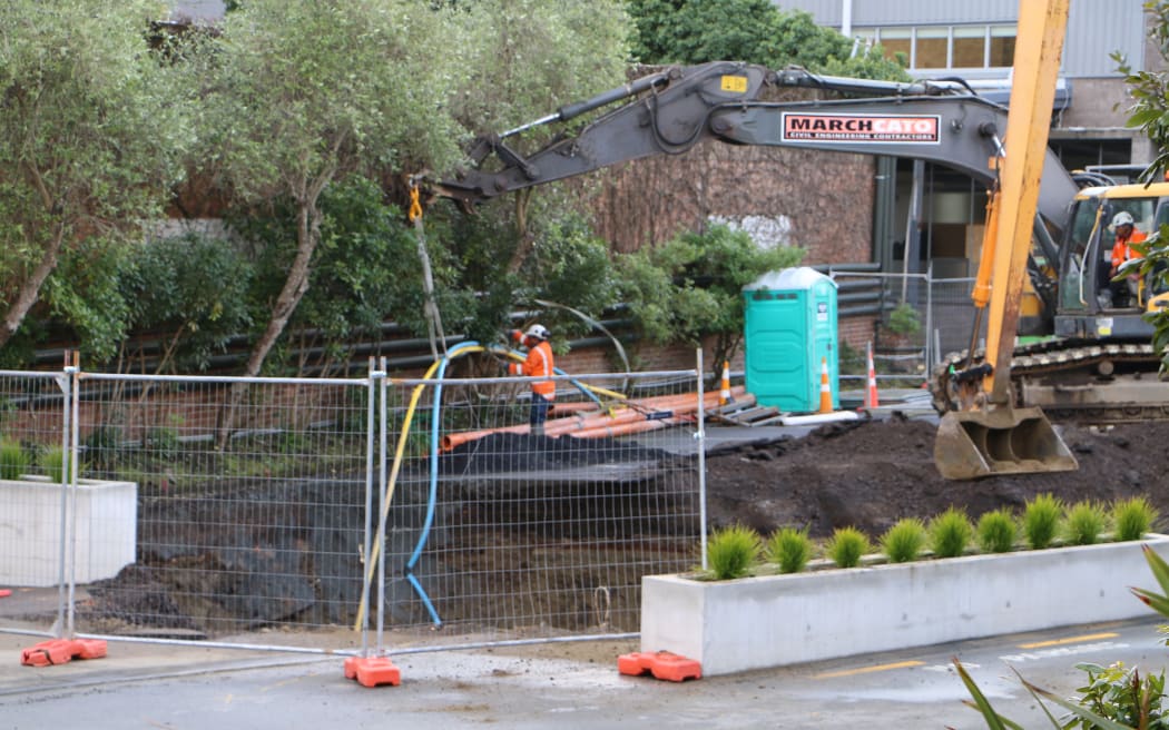 Workers at the sinkhole in Parnell, Auckland, that opened up after a main sewer line collapsed.
