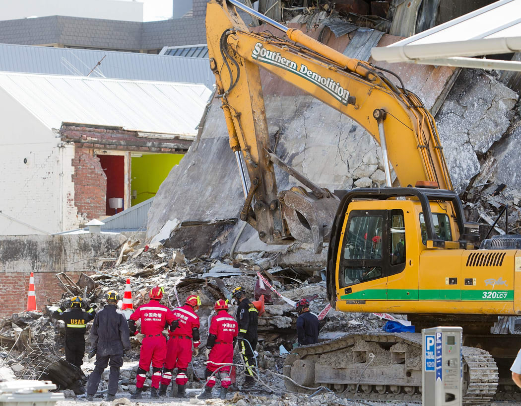 Urban Search and Rescue teams from New Zealand and China work on the wreckage of the CTV building.
