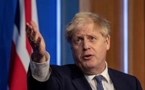 Britain's Prime Minister Boris Johnson speaks during a virtual press conference to update the nation on the status of the Covid-19 pandemic, in the Downing Street briefing room in central London on January 4, 2022.)