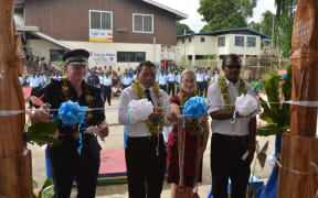 Cutting of the ribbon to officially open the new Auki Police station (From left to right) Commissioner of RSIPF, Frank Prendergast; Ministry of Police, Hon. Peter Shanel Agovaka; RAMSI Special Coordinator, Justine Braithwaite; and Deputy Premier of Malaita Province, Hon. Alick Maeaba.