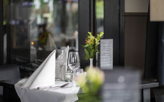 Elegant table setting at a sidewalk cafe, awaiting guests. (Photo by Pancake Pictures / Image Source / Image Source via AFP)