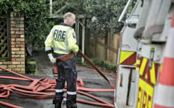 Fire and Emergency pump out water from a property on Grove Road in Auckland’s Devonport on 1 February following flooding.