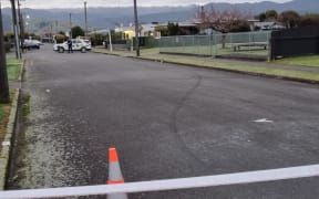 An empty street with visible police car.