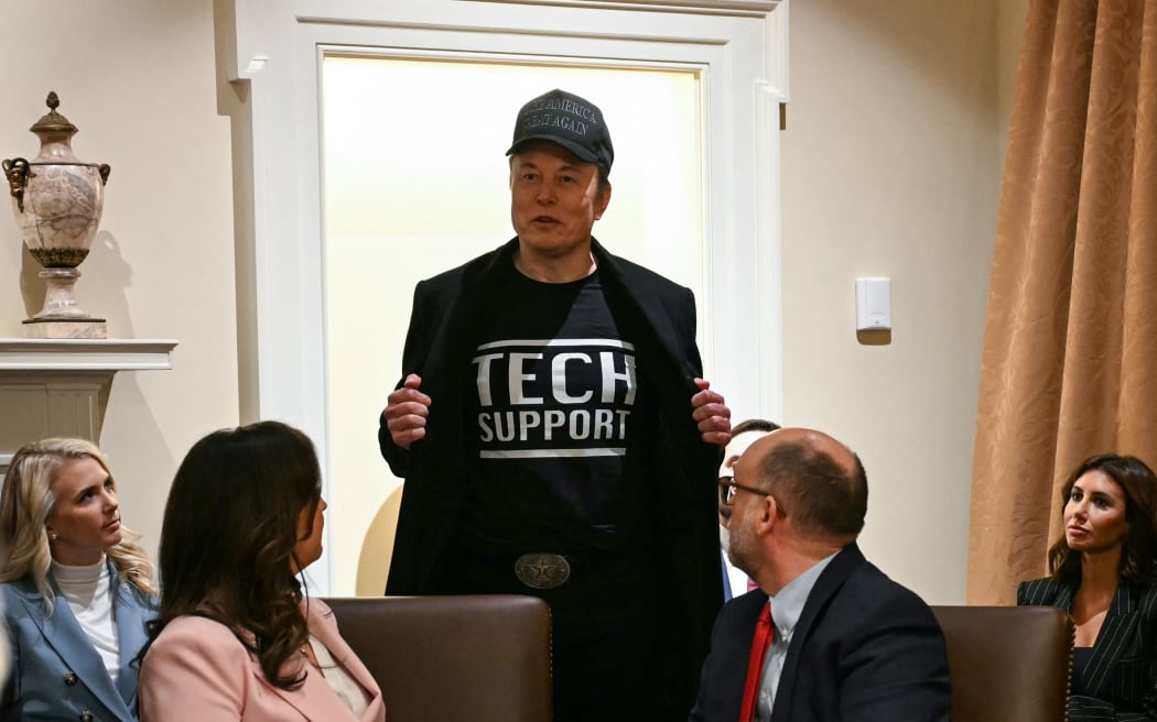 Leader of the Department of Government Efficiency Elon Musk wears a shirt that says "Tech Support" as he speaks during a cabinet meeting with US President Donald Trump at the White House in Washington, DC, on February 26, 2025. (Photo by Jim WATSON / AFP)