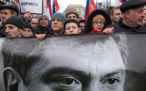 Russia's opposition supporters carry a banner bearing a portrait of Kremlin critic Boris Nemtsov.