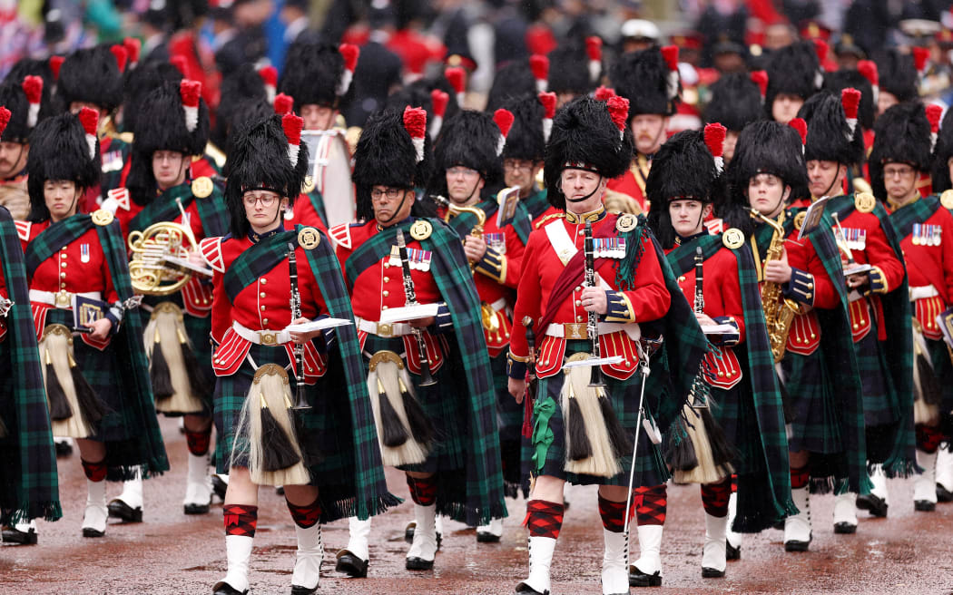 The Band of the Royal Regiment of Scotland march on the day of the coronation of Britain's King Charles III and Queen Camillain central London on May 6, 2023. - The set-piece coronation is the first in Britain in 70 years, and only the second in history to be televised. Charles will be the 40th reigning monarch to be crowned at the central London church since King William I in 1066. Outside the UK, he is also king of 14 other Commonwealth countries, including Australia, Canada and New Zealand. Camilla, his second wife, will be crowned queen alongside him, and be known as Queen Camilla after the ceremony. (Photo by Richard Heathcote / POOL / AFP)