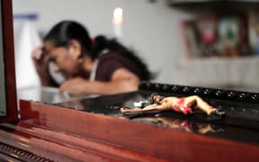 A woman attends Miguel Angel Jimenez Blanco's wake in Xaltianguis, Guerrero State, Mexico, on 9 August.