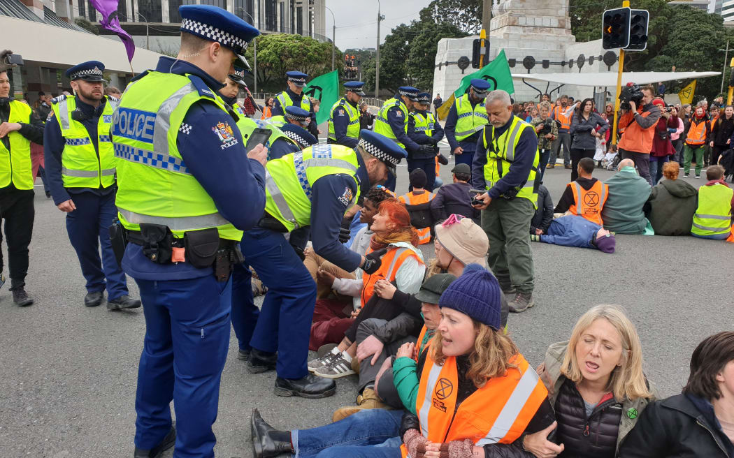 Police talk to climate change protesters in Wellington.