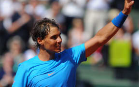 The nine times French Open champion Rafael Nadal celebrates after winning his match at Roland Garros.