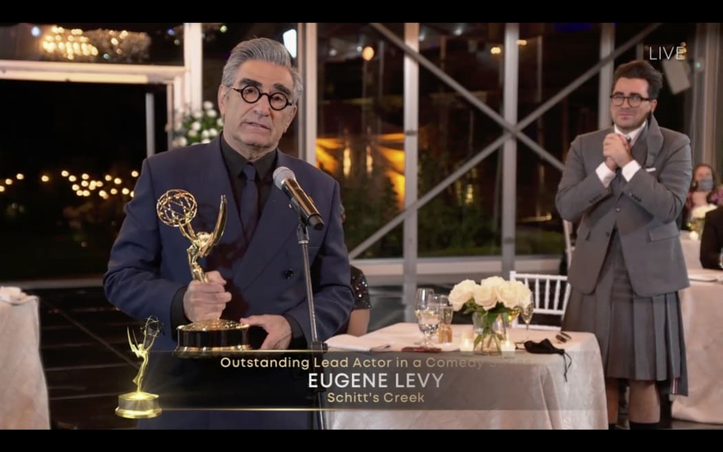 Canadian actor Eugene Levy speaks after receiving his Emmy while his son actor/director/writer Daniel Levy watches during the 72nd Primetime Emmy Awards ceremony held virtually on September 20, 2020.