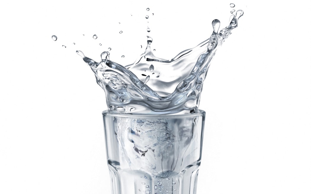 Glass full of water with splash. Isolated on white background. (Photo by LEONELLO CALVETTI/SCIENCE PHOTO / LCL / Science Photo Library via AFP)
