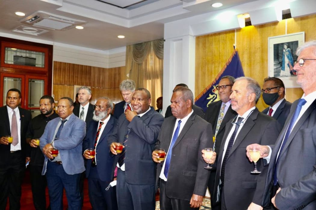 PNG's government celebrates the signing of the Papua LNG Project Agreement with representatives of developers Total and partners ExxonMobil and Oil Search. 9 February, 2021