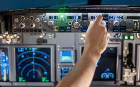 man hand operate switch on airplane panel