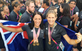 Opening ceremony flag bearer Sophie Pascoe with closing ceremony flag bearer Stacey Michelsen