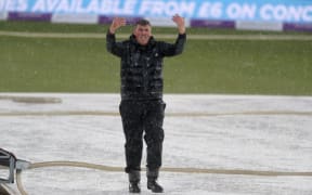 Head Groundsman, Lee Fortis, goes to work in a hailstorm during the first one day international between England and Pakistan at the Kia Oval,