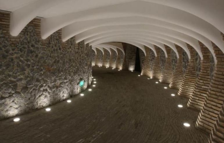 A subterranean entrance to the Marisfrolg Headquarters made from concrete, recycled bricks and stone.