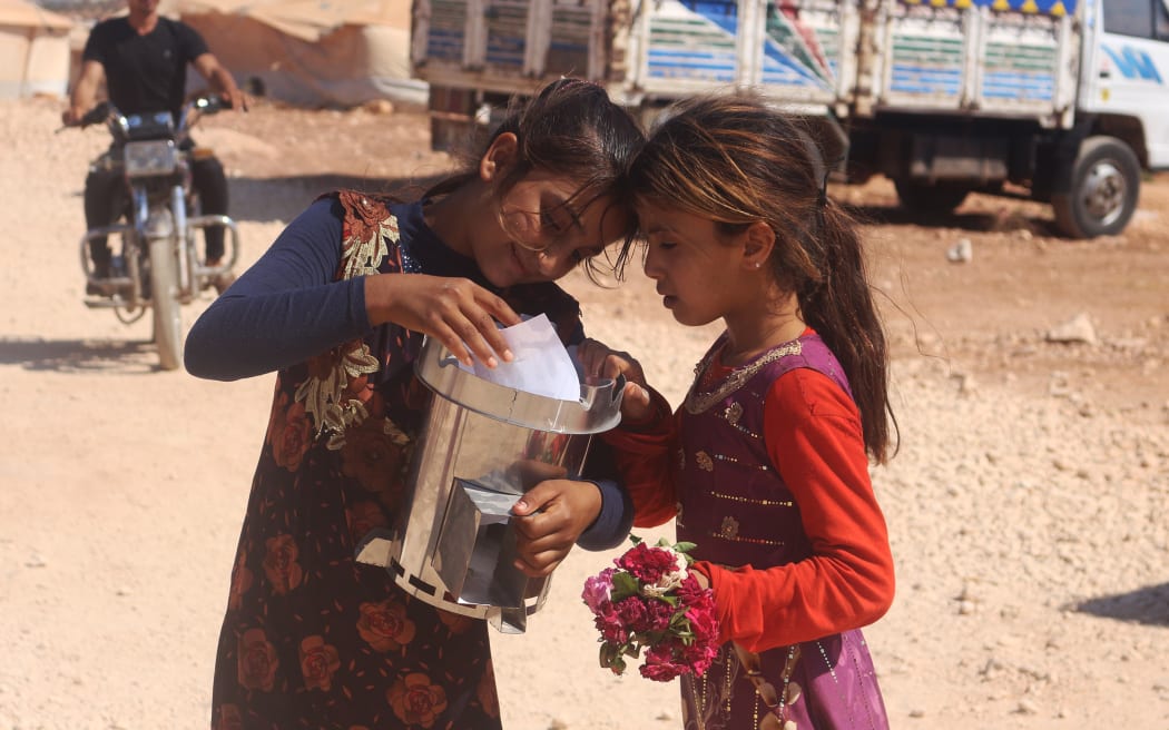 Syrian Girls with Escea 'Fire For Life' Stove