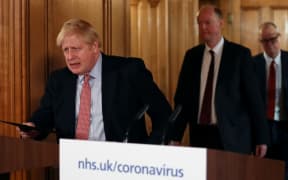 Britain's Prime Minister Boris Johnson  arrives at a news conference addressing the government's response to the novel coronavirus COVID-19 outbreak, at 10 Downing Street.