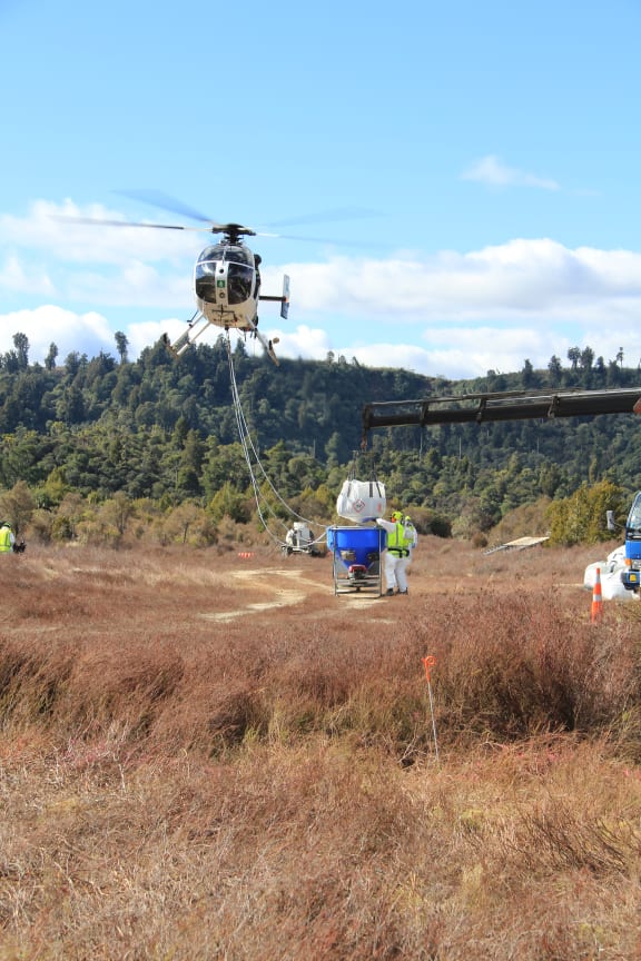 A bait bucket being refilled during an aerial 1080 operation in the Tongariro Conservation Area