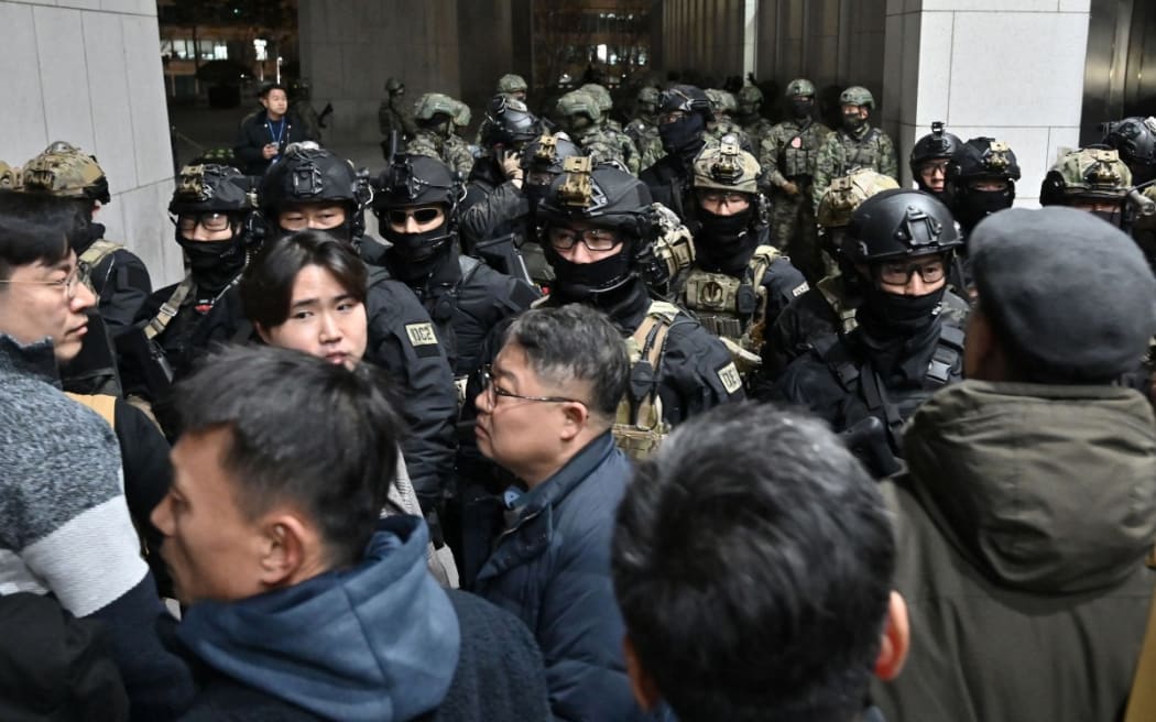 Soldiers try to enter the National Assembly building in Seoul on December 4 2024, after South Korea President Yoon Suk Yeol declared martial law.