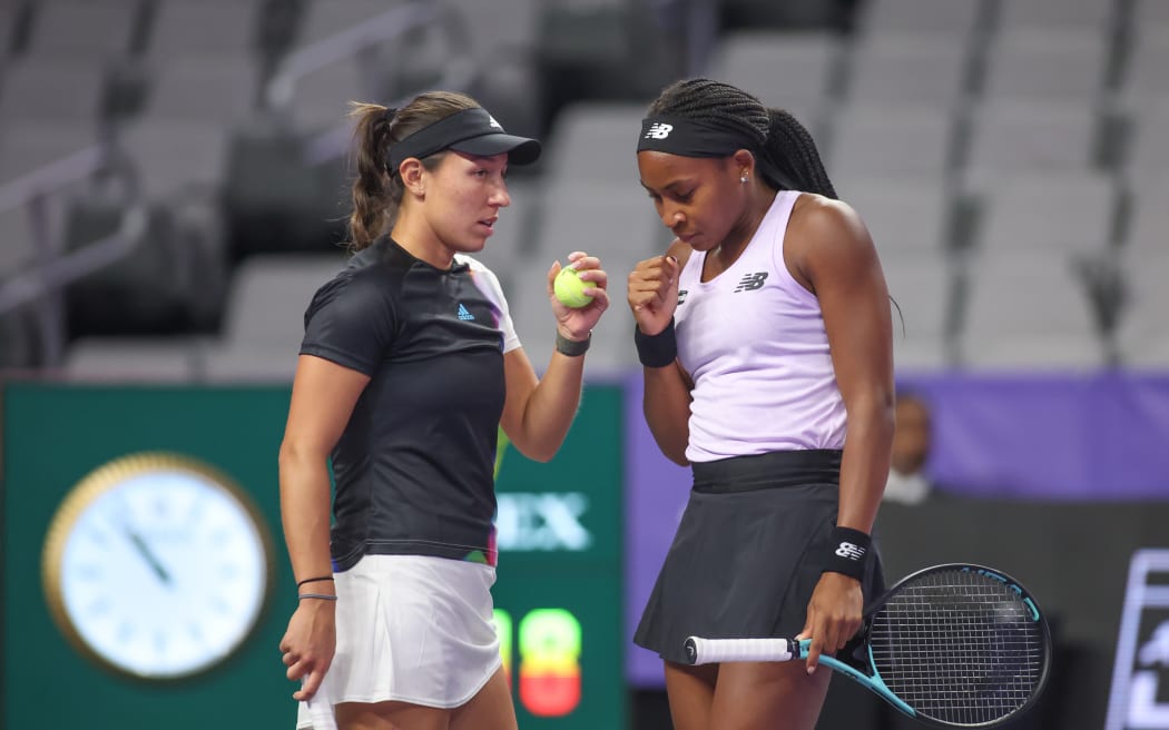 Jessica Pegula (USA) and Coco Gauff (USA) discuss strategy during a doubles match