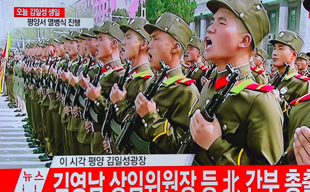 A television screen broadcasting live footage of the ceremony to mark the 105th anniversary of the birth of North Korea's founder Kim Il-Sung.