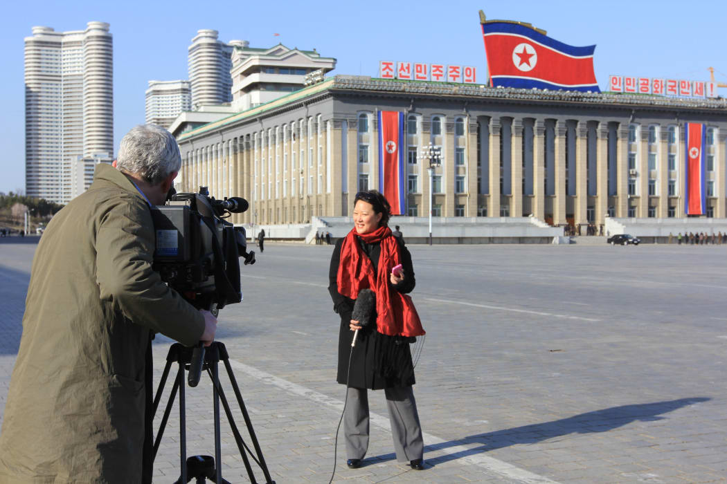 PYONGYANG, North Korea — In this photo, journalist Jean H. Lee prepares to give a live broadcast from Kim Il Sung Square in Pyongyang, North Korea, on April 14, 2013. In 2011, Lee became the first American journalist granted permission to join the foreign press corps in North Korea, and she opened the AP news agency’s Pyongyang bureau in 2012 as bureau chief. (Photo courtesy of Jean H. Lee)