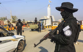 A member of the Taliban security forces stand guard at a checkpoint along a street in Jalalabad on 6 December, 2022.