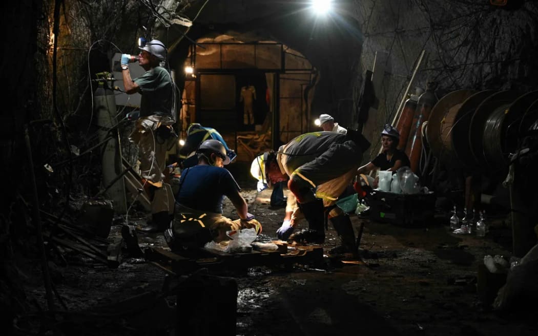 A team of scientists hunt for microbes at a study site in a 3-kilometer-deep (9,500-foot-deep) mine in South Africa.