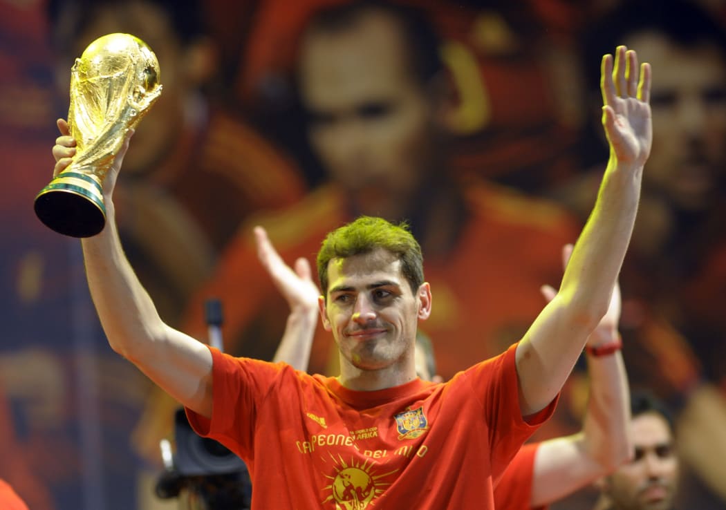 Spain's goalkeeper Iker Casillas holds up the trophy on a stage set up for the Spanish team victory ceremony in Madrid on July 12, 2010.