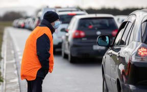 Cars line up as people wait to be tested for Covid-19 at the Orchard Road drive-through testing centre in Christchurch