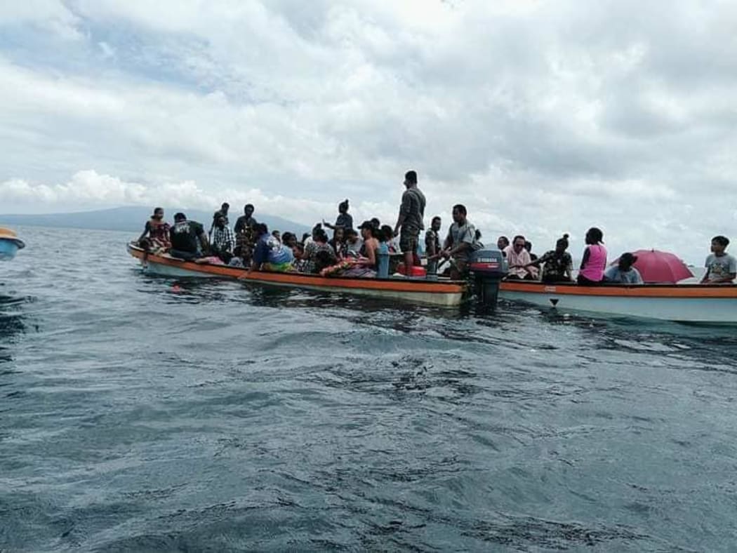Families of the 14 victims head out to sea to lay wreaths during the memorial service in Gizo.