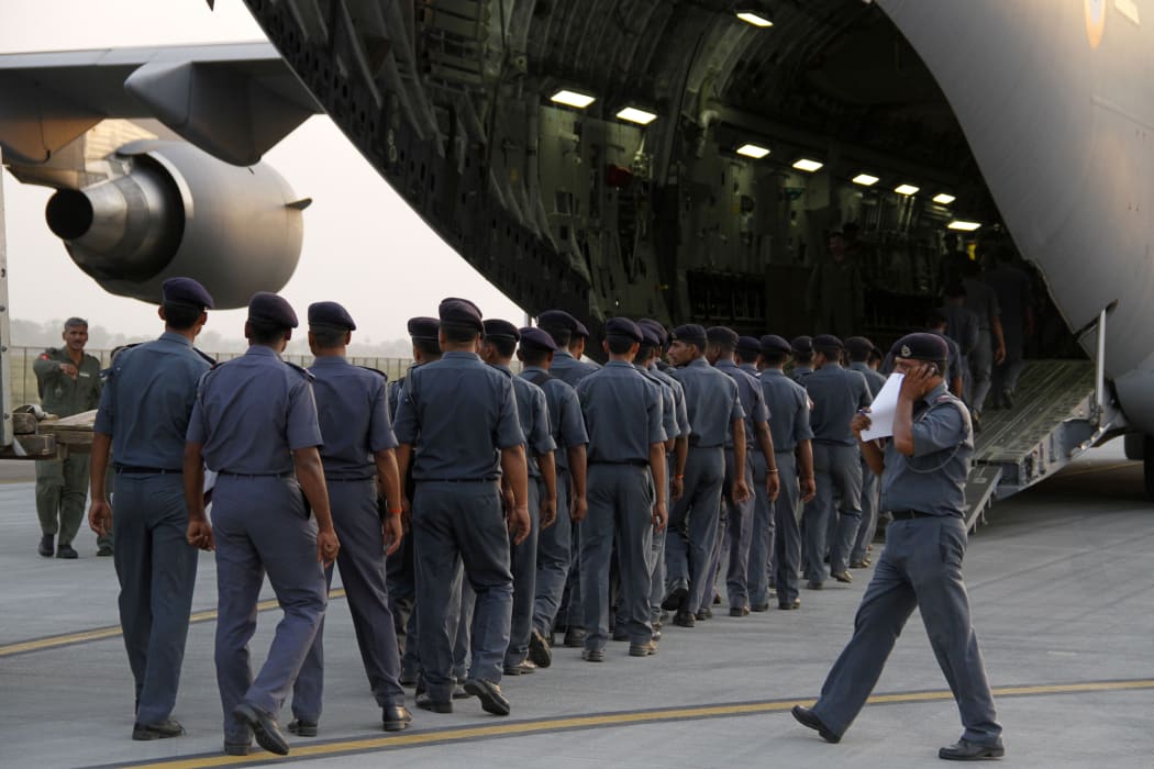 Members of India's National Disaster Response Force (NDRF) prepare to fly to Nepal.