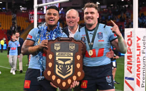 Michael Maguire flanked by Blues players Spencer Leniu (left) and Angus Crichton after NSW sealed the State of Origin title in July.