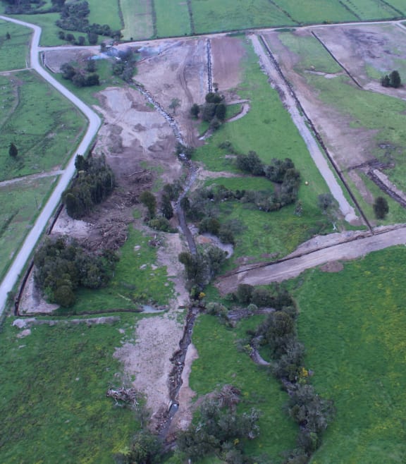 The stream was diverted into the constructed channel (centre) from its natural course (shown by the natural vegetation).