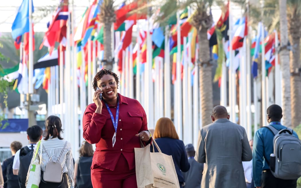 Participants walk on the allies of conference venue during the COP28, UN Climate Change Conference, held by UNFCCC in Dubai Exhibition Center, United Arab Emirates on December 4, 2023. COP28, running from November 30 to December 12 focuses on particular nations' decarbonisation goals. The Conference in Dubai focuses also on the most vulnerable communities and Loss and Damage (Photo by Dominika Zarzycka/NurPhoto) (Photo by Dominika Zarzycka / NurPhoto / NurPhoto via AFP)