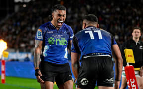 Rieko Ioane celebrates a try by Caleb Clarke in the Super Rugby Pacific final.