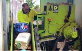Feeding containers being put in the Agrecovery mobile processing truck.