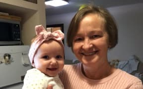 Mariia Chekis with her granddaughter