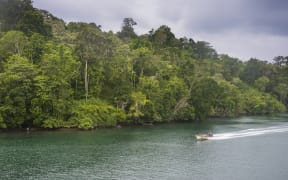 A boat on a river in the jungle of Manus Island