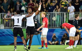 Fiji's Viliame Mata (2nd left) and Apisai Domolailai (L) celebrate Olympic gold.