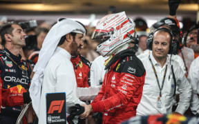 FIA president Mohammed Ben Sulayem (L) congratulates Ferrari driver Charles Leclerc.
