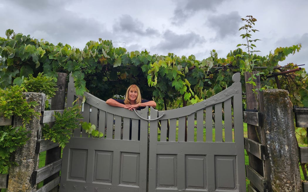 Lorenza Devcich with grapevines thought to have been planted about 80 years ago