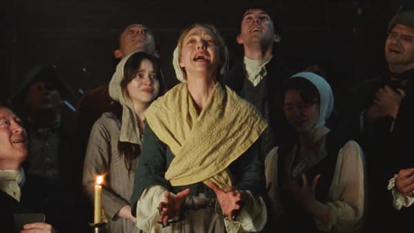 Amanda Seyfried looks up and cries out with her ten fingers splayed.