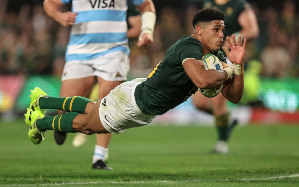 South Africa's fly-half Sacha Feinberg-Mngomezulu dives to score a try, 2025.