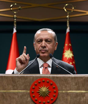 Turkish President Recep Tayyip Erdogan speaks to people demonstrating against the failed military coup attempt.