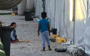 Children outside RPC3 tents.